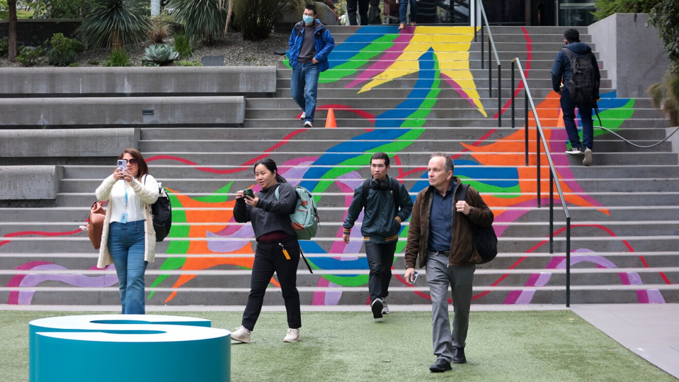 Amazon employees gather outside of the Seattle headquarters before heading into the lobby to start their workdays.