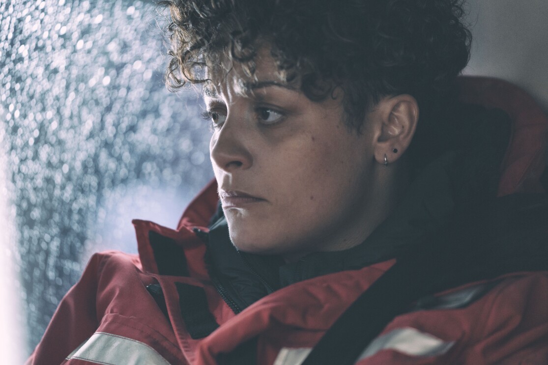 Rochenda Sandall wearing a red jacket and looking pensive in The Rig season 2