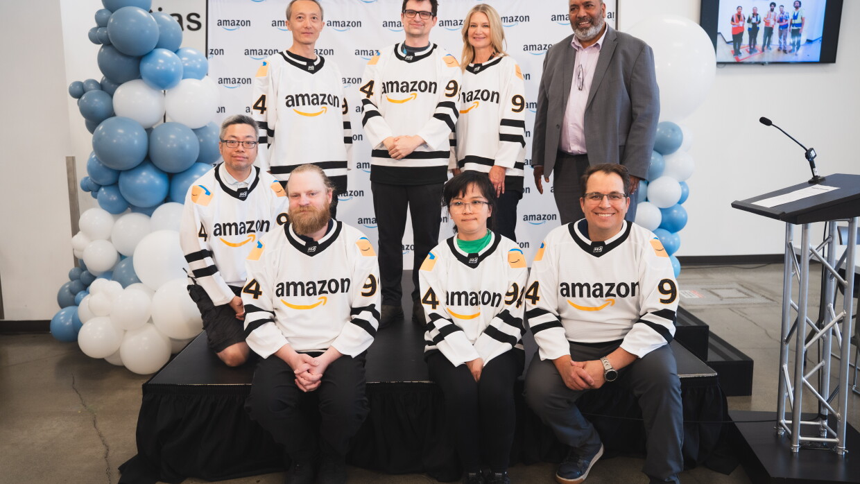 YVR3 employees posing in Amazon jerseys.