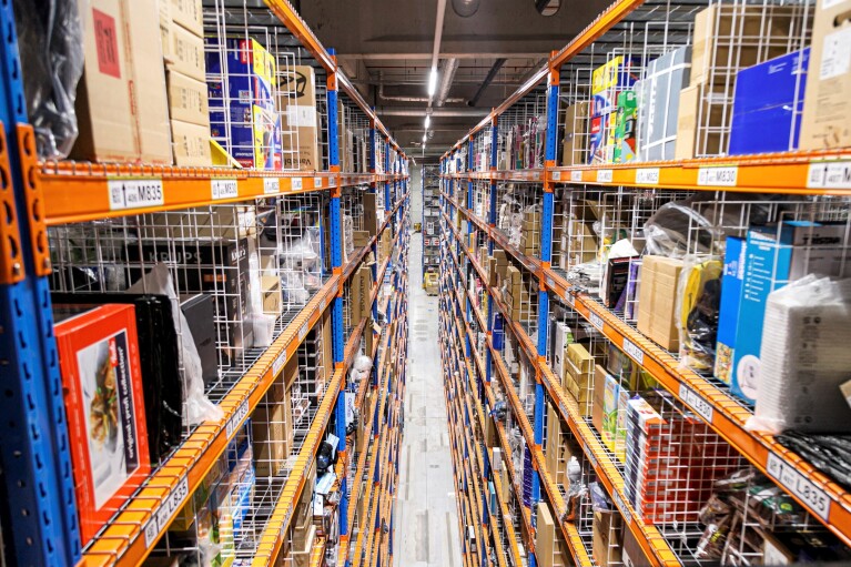 Ein Hochregallager von oben fotografiert: man sieht die meterhohen Regale mit eingelagerter Ware.