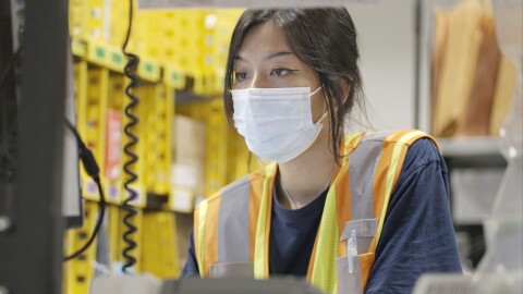 Amazon associate Kathie Koh is seen working at Amazon's Fulfillment Center in Singapore