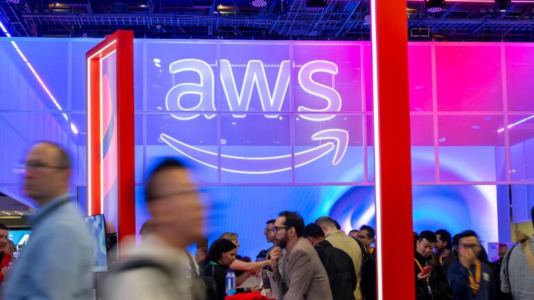 Amazon Web Services branding at conference with people networking