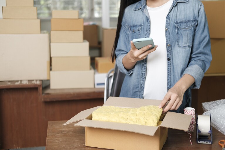 Online business owner preparing product to customer