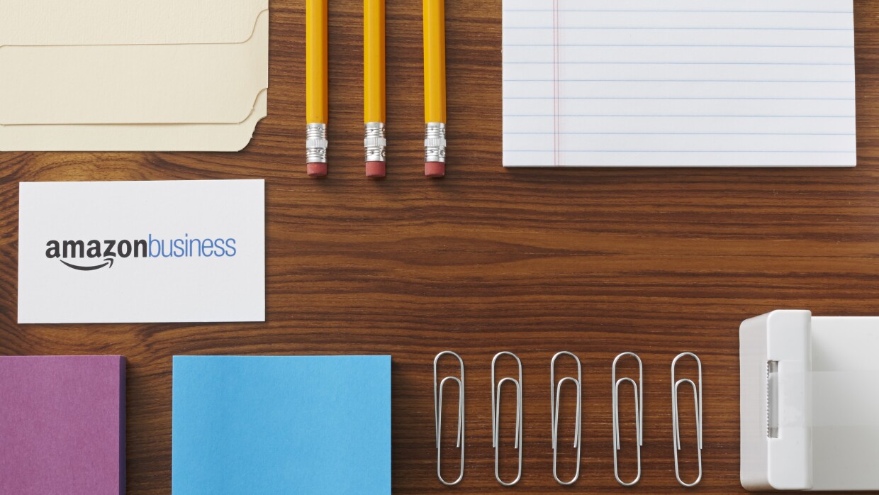 Amazon Business card surrounded by office supplies