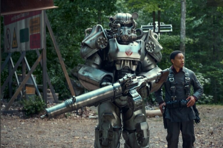 A man standing next to a gigantic robot