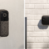Two smart home security cameras mounted on exterior walls
