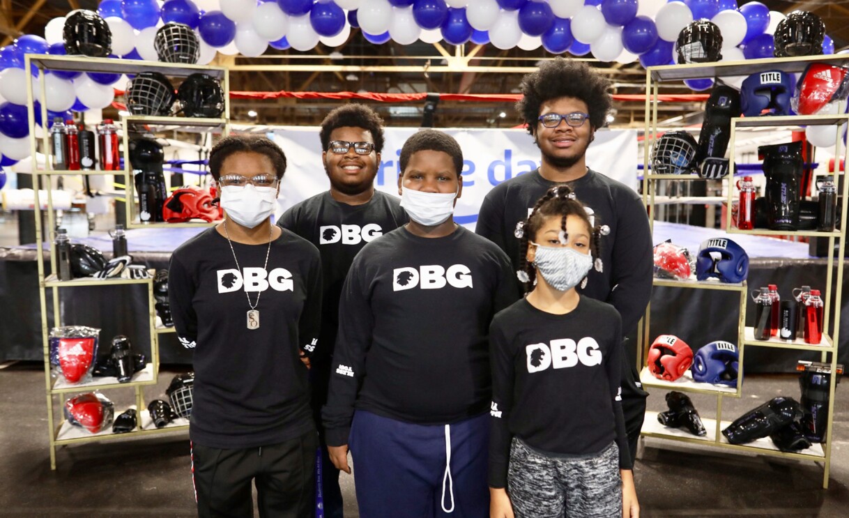 Amazon employees surprise nonprofits and schools with donations of various items.