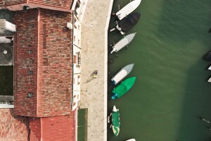 Photos of an aerial view of the Lagoon and an Amazon delivery driver handing over a delivery to a customer at his doorstep.