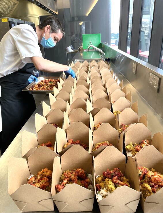 Alex Borley from BaxterStorey packing food boxes to donate to the local Shoreditch community. 