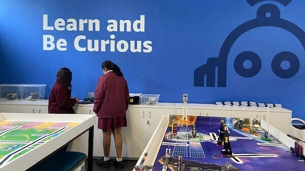 A photo of two students working the the AWS Think Big Space in Sydney, Australia.
