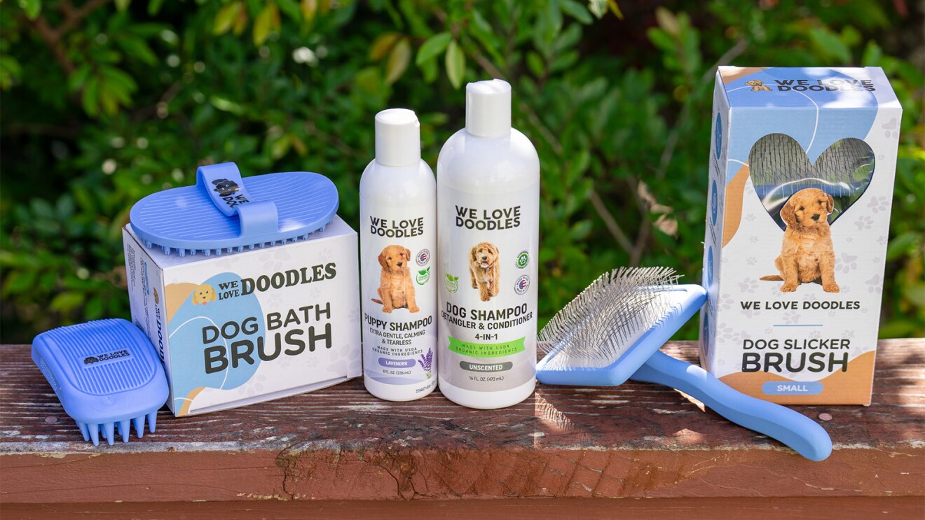 Dog grooming products from 'We Love Doodles' brand displayed outdoors