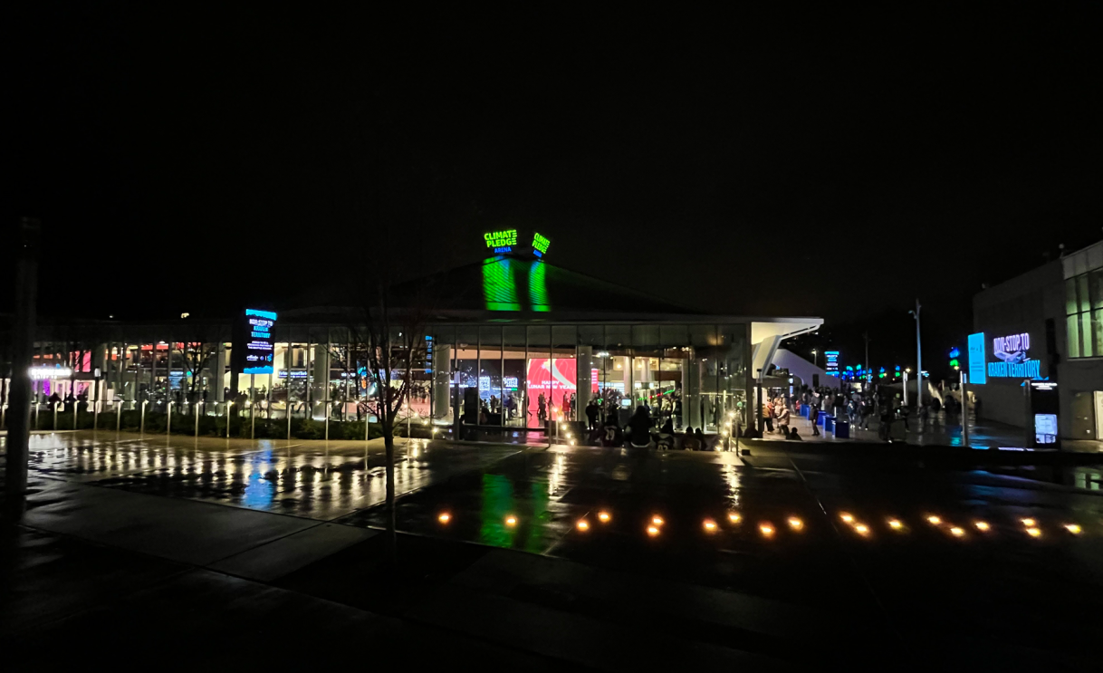 An image of the Climate Pledge Arena at night with lights around it.