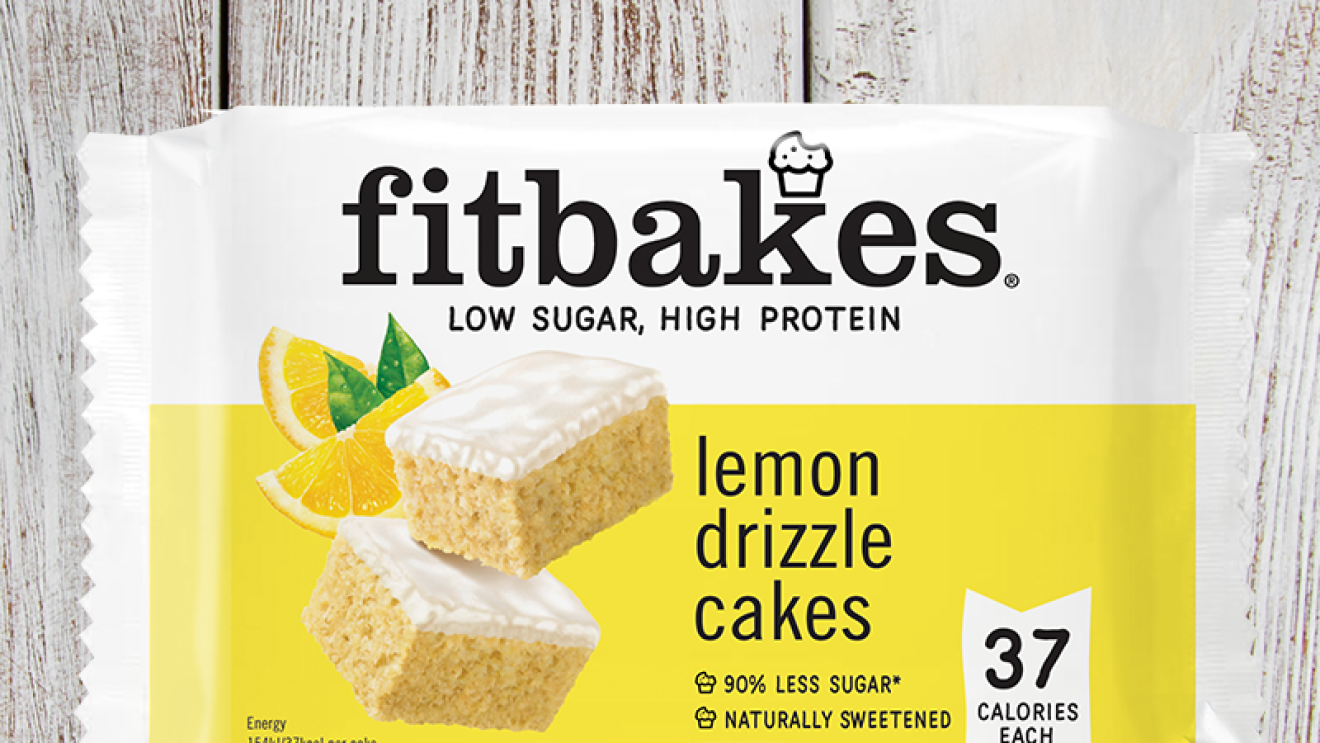 An image of a lemon flavoured Fitbakes on a wooden table with lemons at the bottom.