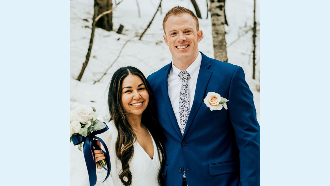 Josh stands next to his wife on their wedding day.