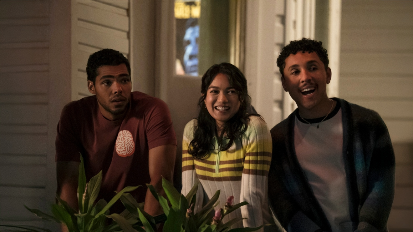 Rachel Marsh, Nicholas Duvernay, and Jaboukie Young-White smiling together as they stare out off of a balcony