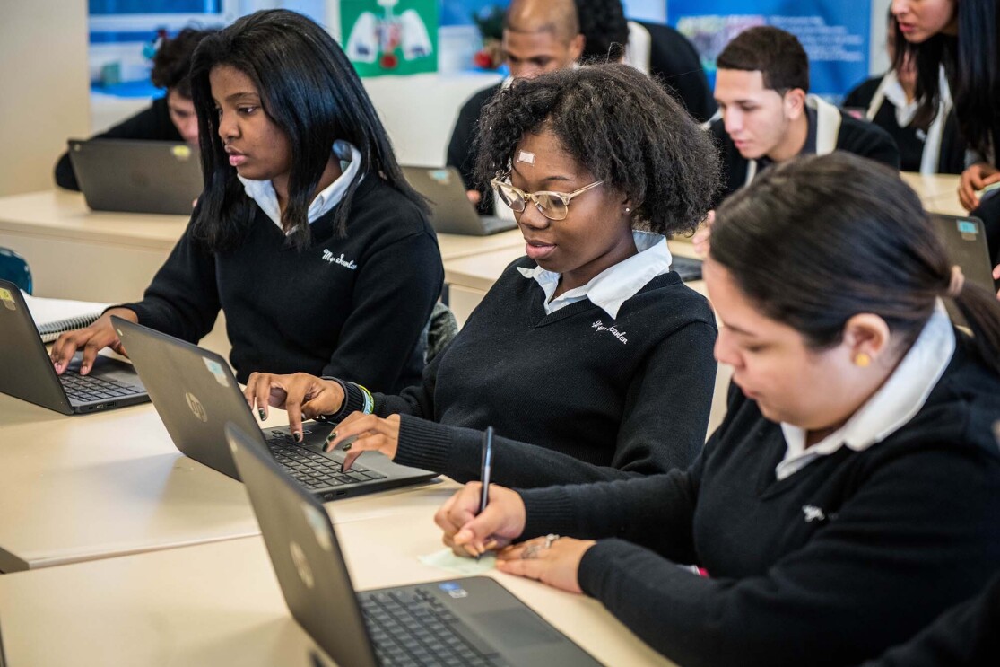 Students at Monsignor Scanlan High School working on laptop computers as they learn about computer science.