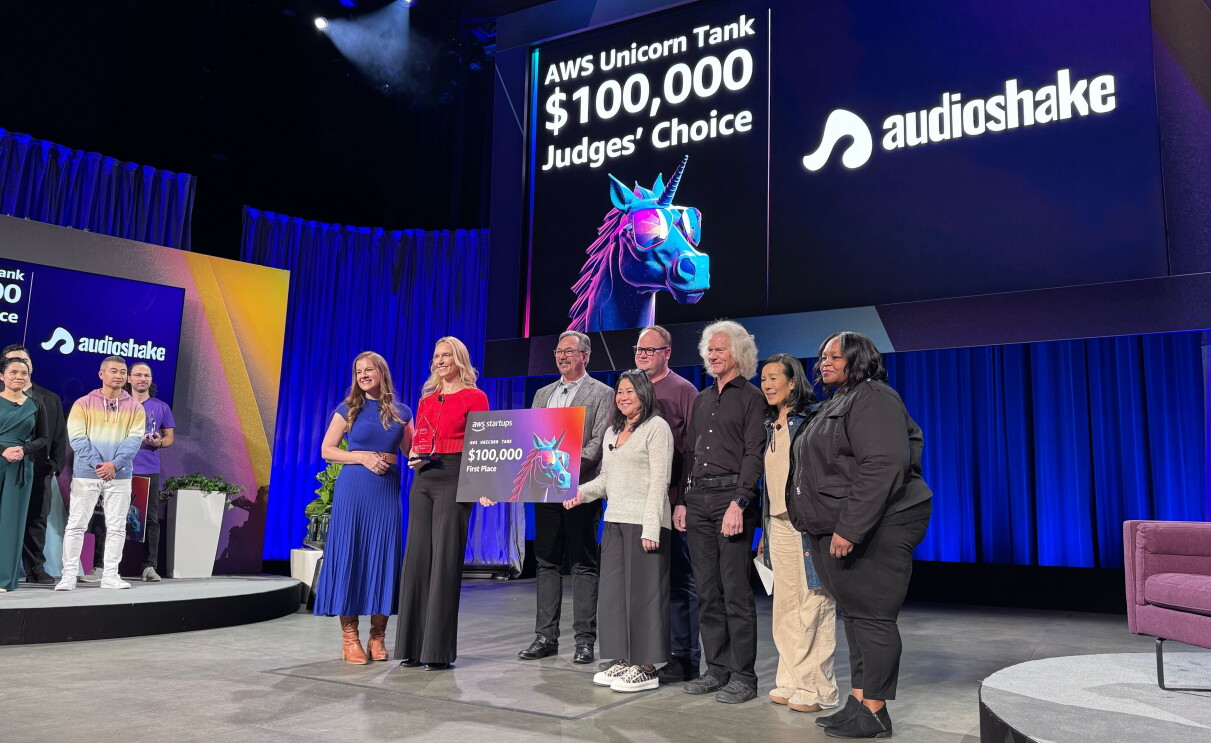 AudioShake team members accepting a check at AWS Unicorn Tank pitch competition.