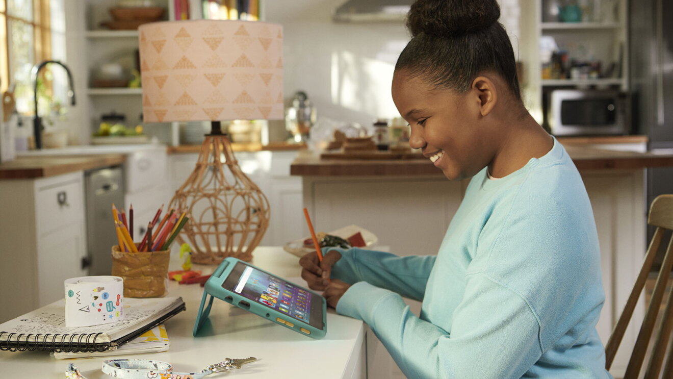 An image of a child using Amazon's Kids Fire Tablet in their home.