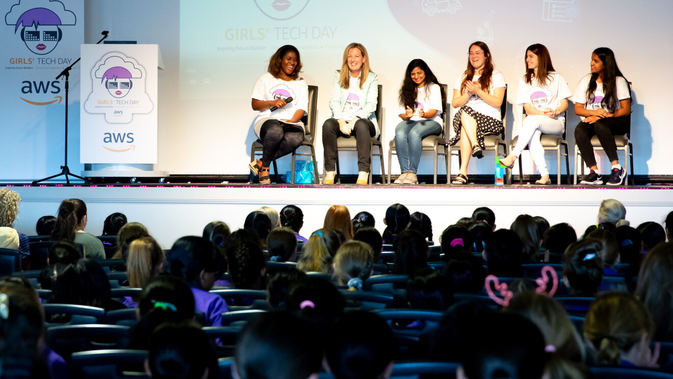 AWS InCommunities - Participating ladies and representatives of AWS, among them Cornelia Robinson, Global Leader of AWS InCommunity sit on stage and talk during an AWS InCommunity event