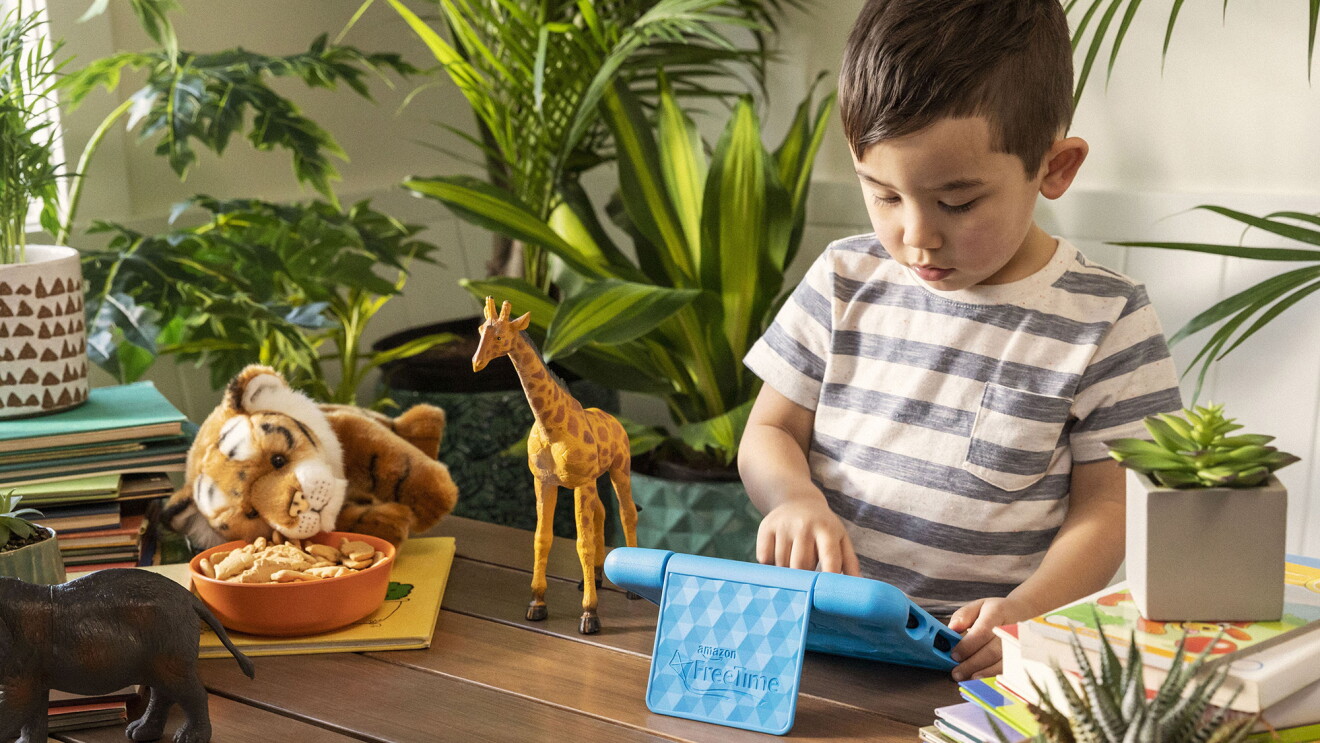 A child plays on a Fire tablet in a living room 
