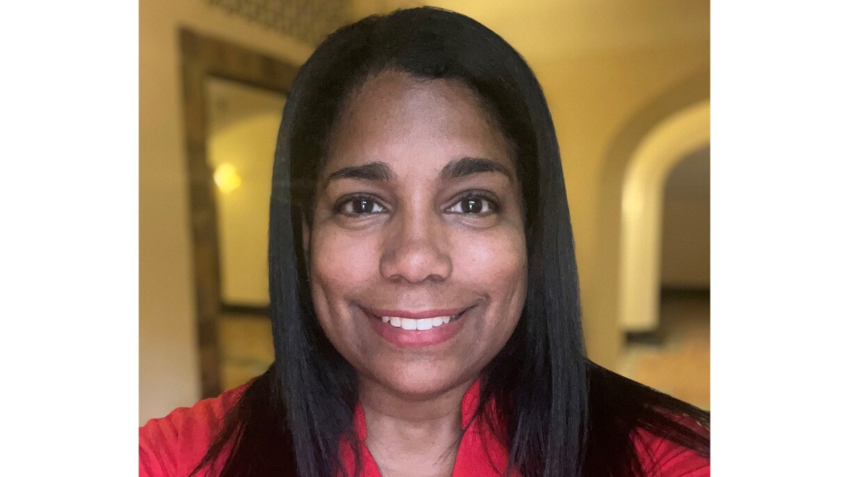 An image of a woman smiling for a close-up headshot photo.