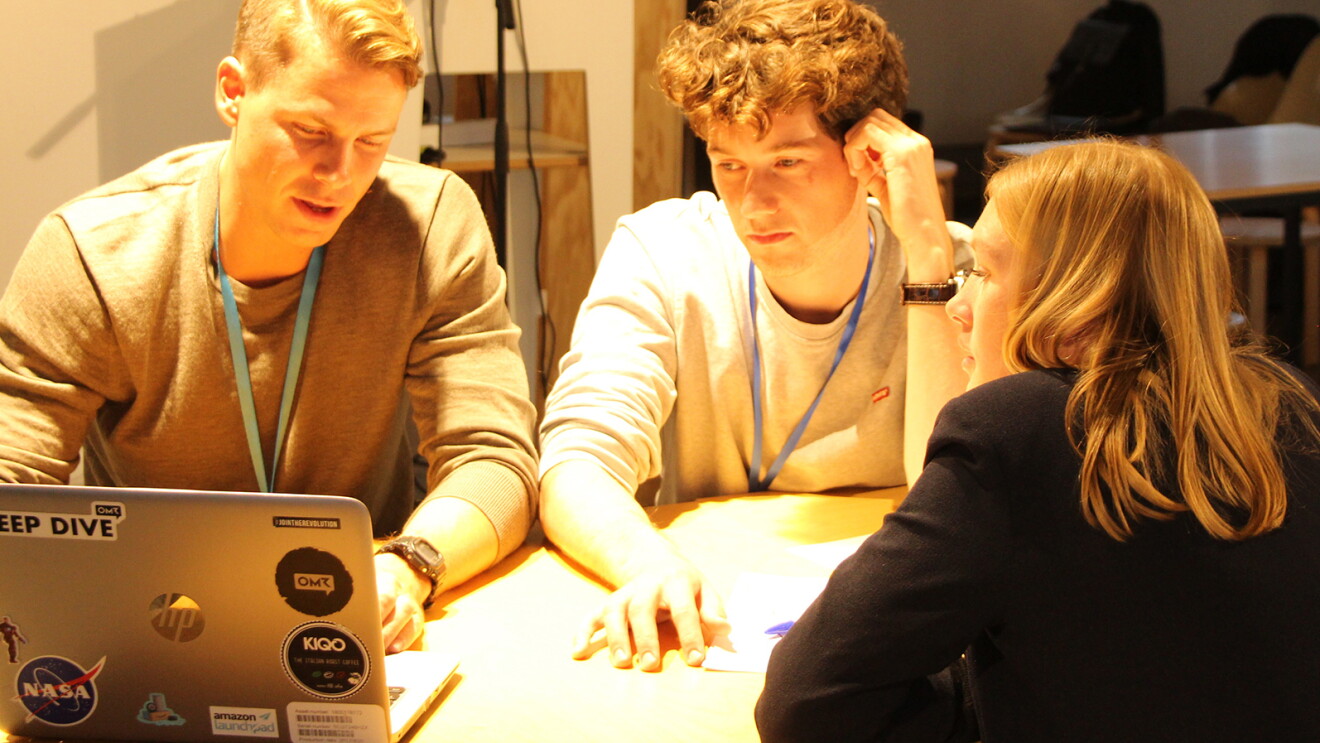 Amazon Launchpad Summit Teilnehmer sitzen am Tisch und besprechen sich.