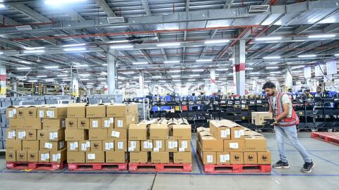 An Amazon employee working at a fulfilment centre