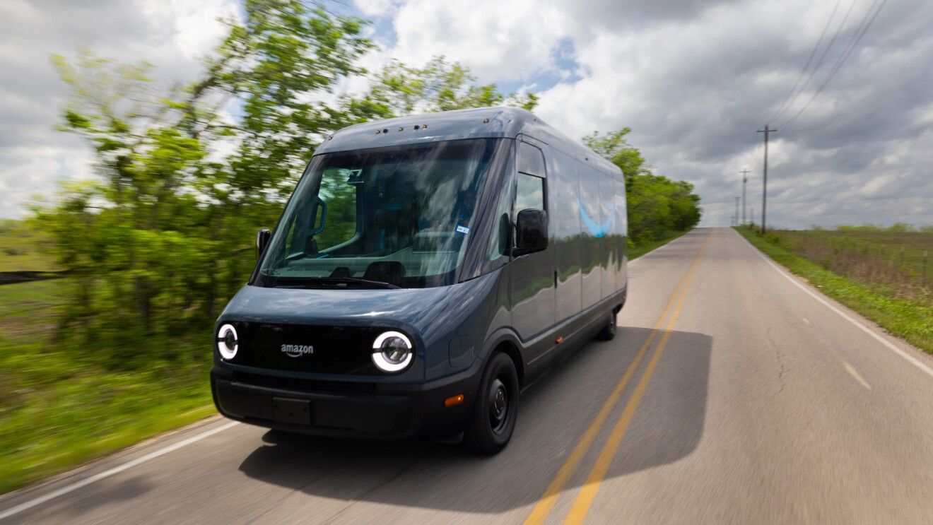 An image of a Rivian delivery van on the road. 