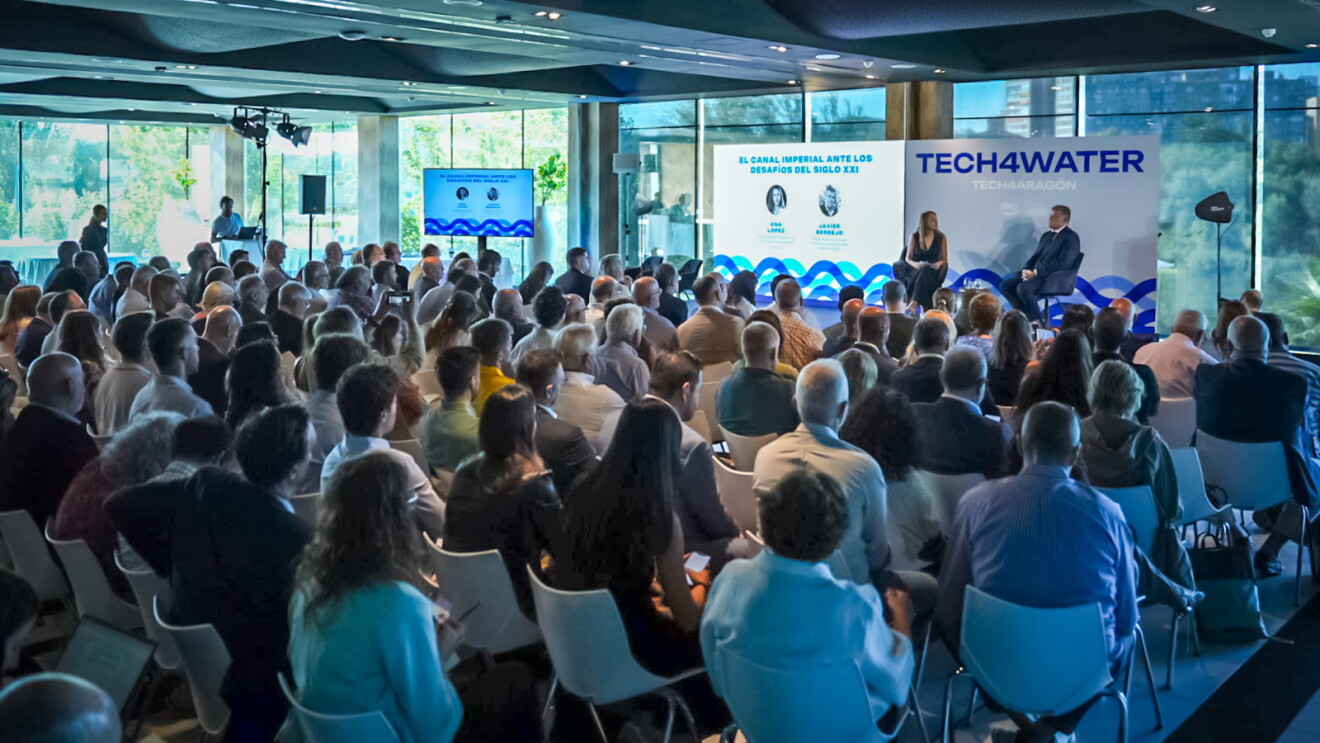TECH4WATER conference with an audience watching two speakers onstage