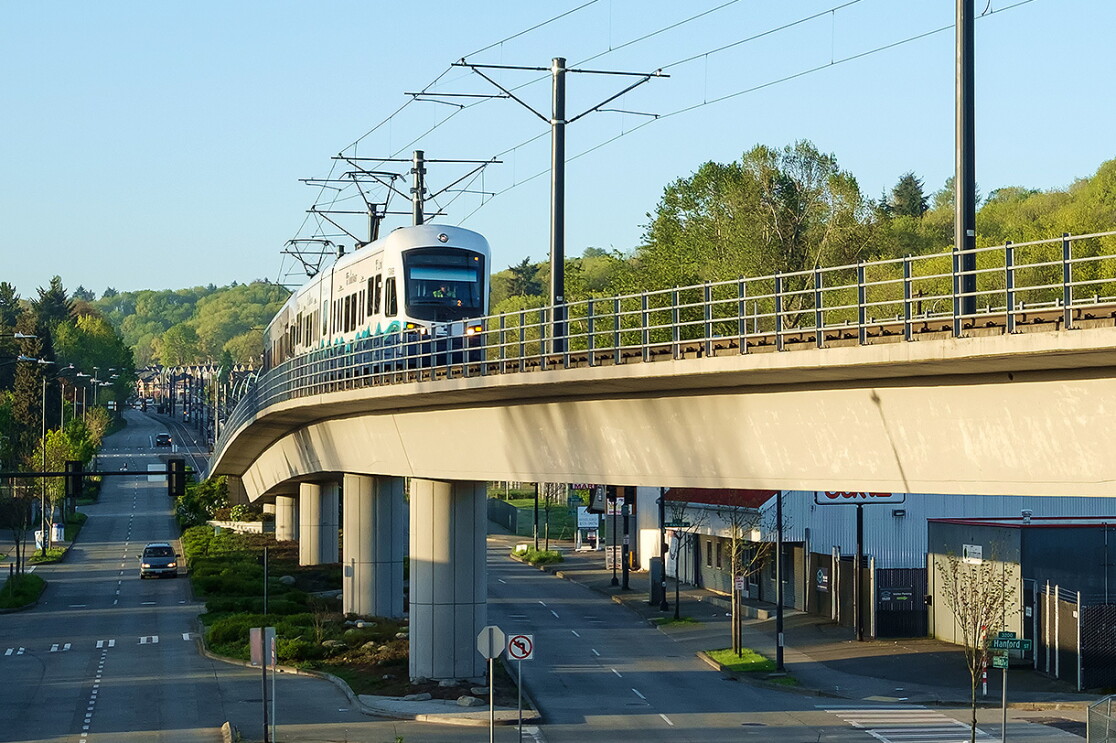 An image of a lightrail driving through a city.