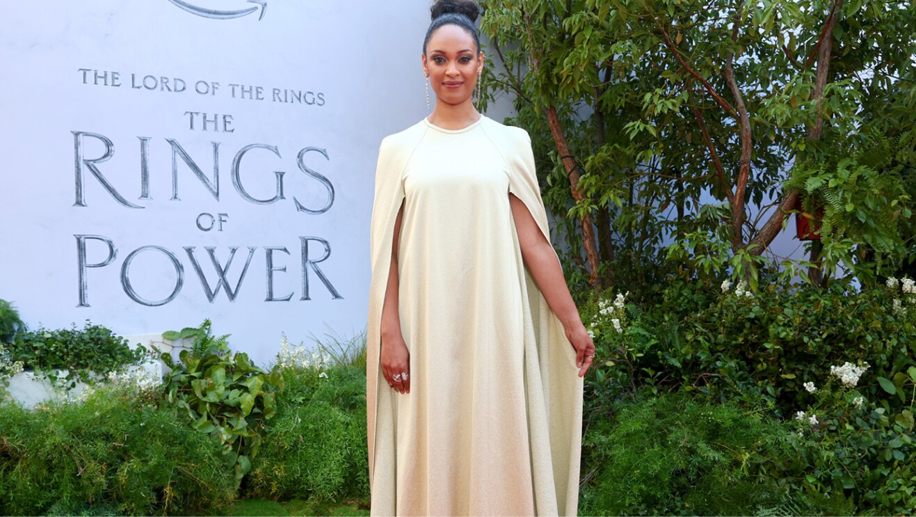 A woman smiles for a photo on the red carpet of the Lord of the Rings the Rings of Power premiere
