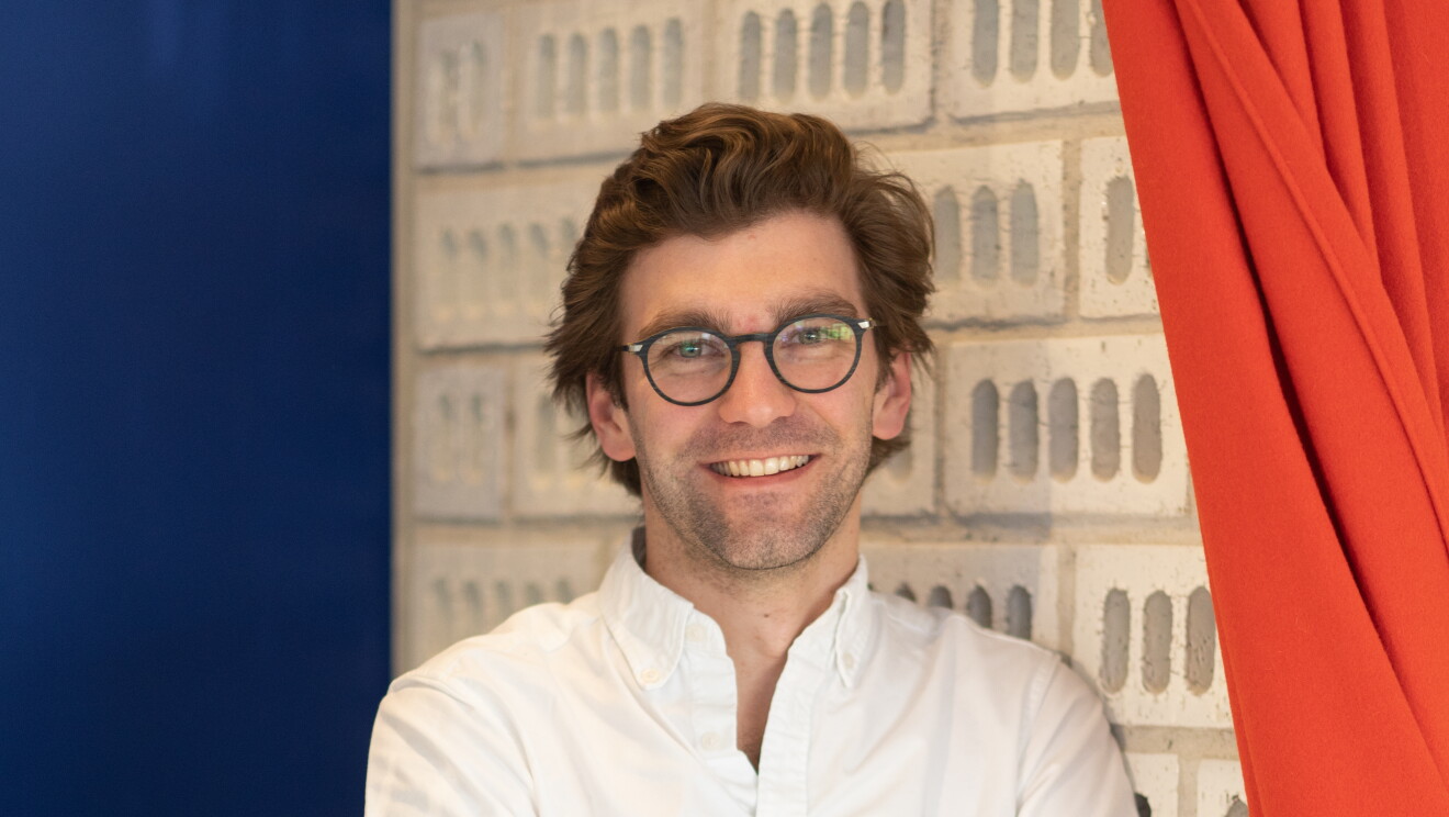 Charles standing in office workspace