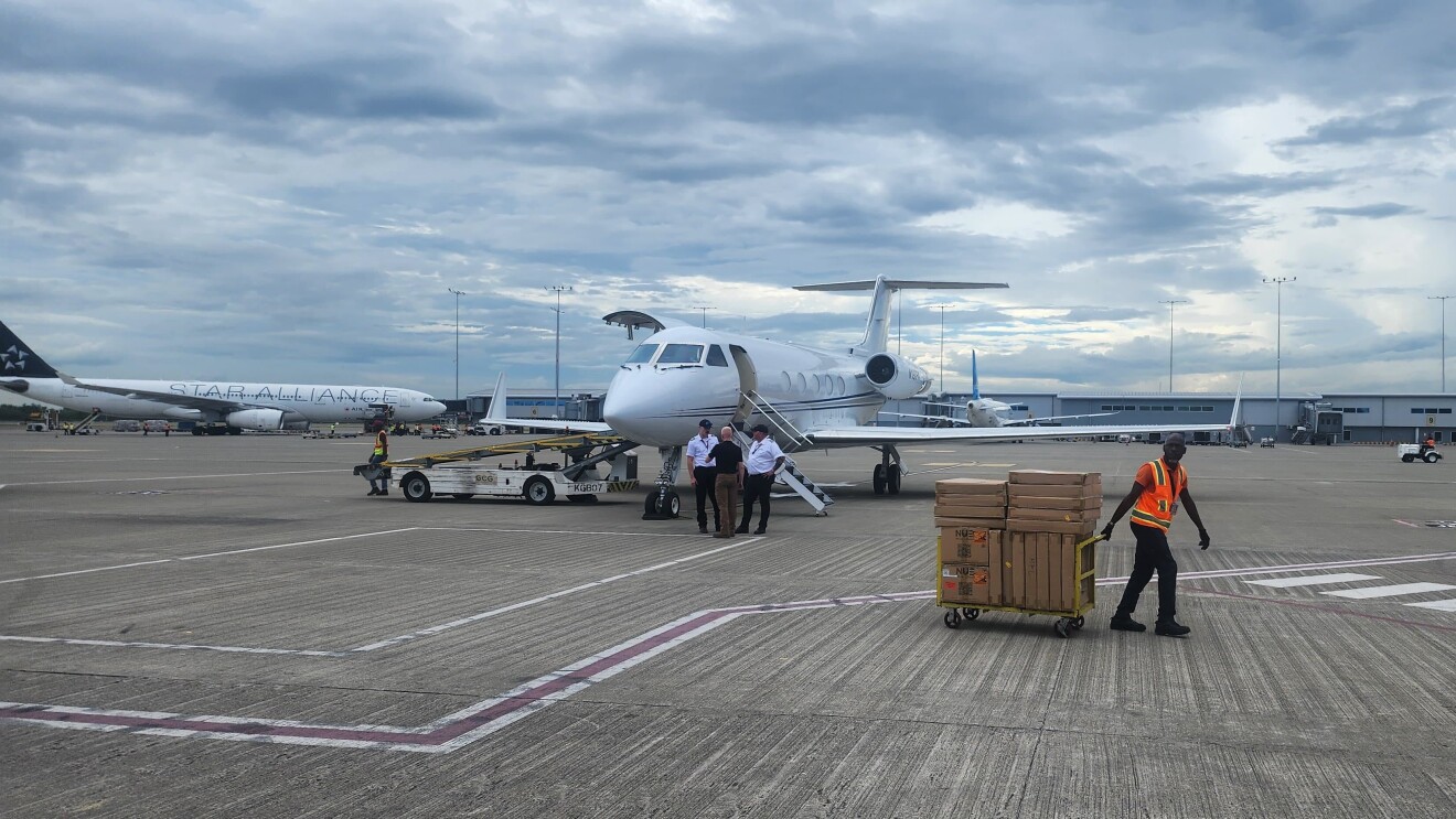 Disaster Relief by Amazon for Hurricane Melissa; Private jet on tarmac with ground crew and cargo loader nearby