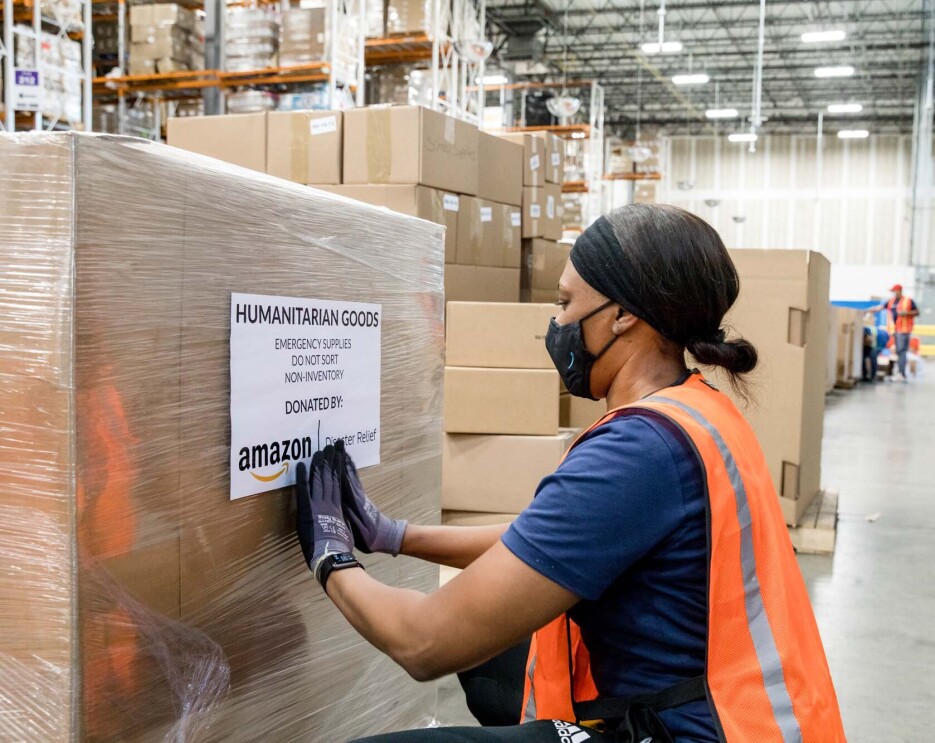 An Amazon employee readies product to be used for disaster relief.