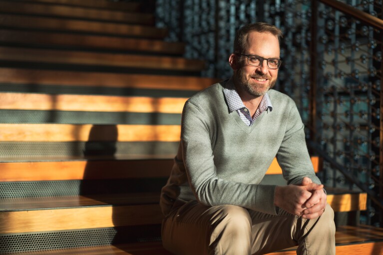 Amazon associate sites on stairs within a shared workspace on Amazon's Seattle campus.
