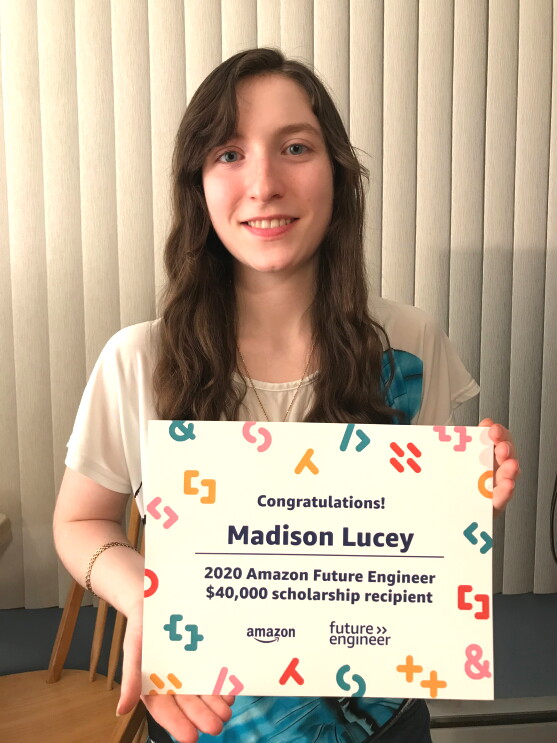 A young woman poses with a certificate that says "2020 Amazon Future Engineer $40,000 scholarship recipient."