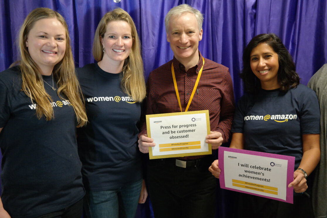 Employees holding certificates at International Women's Day at Amazon