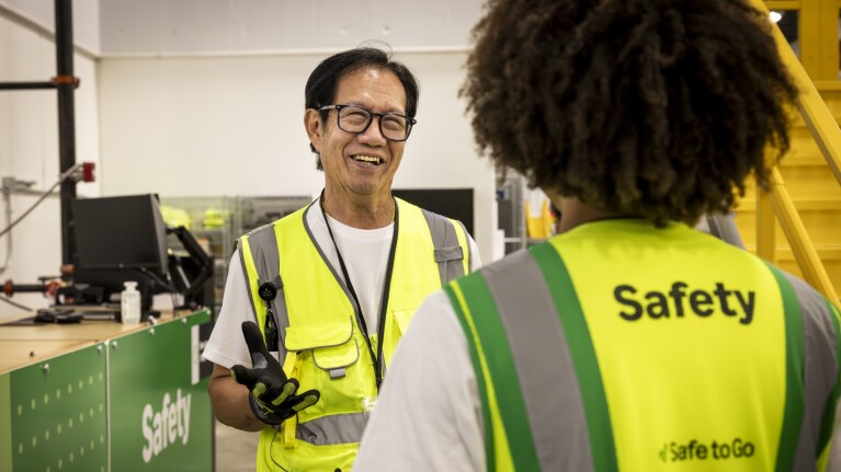 Team members in safety gear at Amazon facility