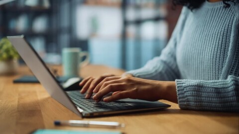 Una imagen de una persona escribiendo en su computadora portátil.