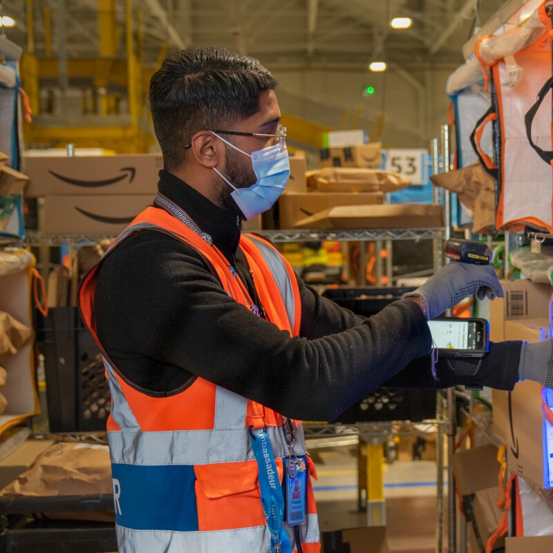 Photos of Amazon associates working in a Fulfillment Center in France.