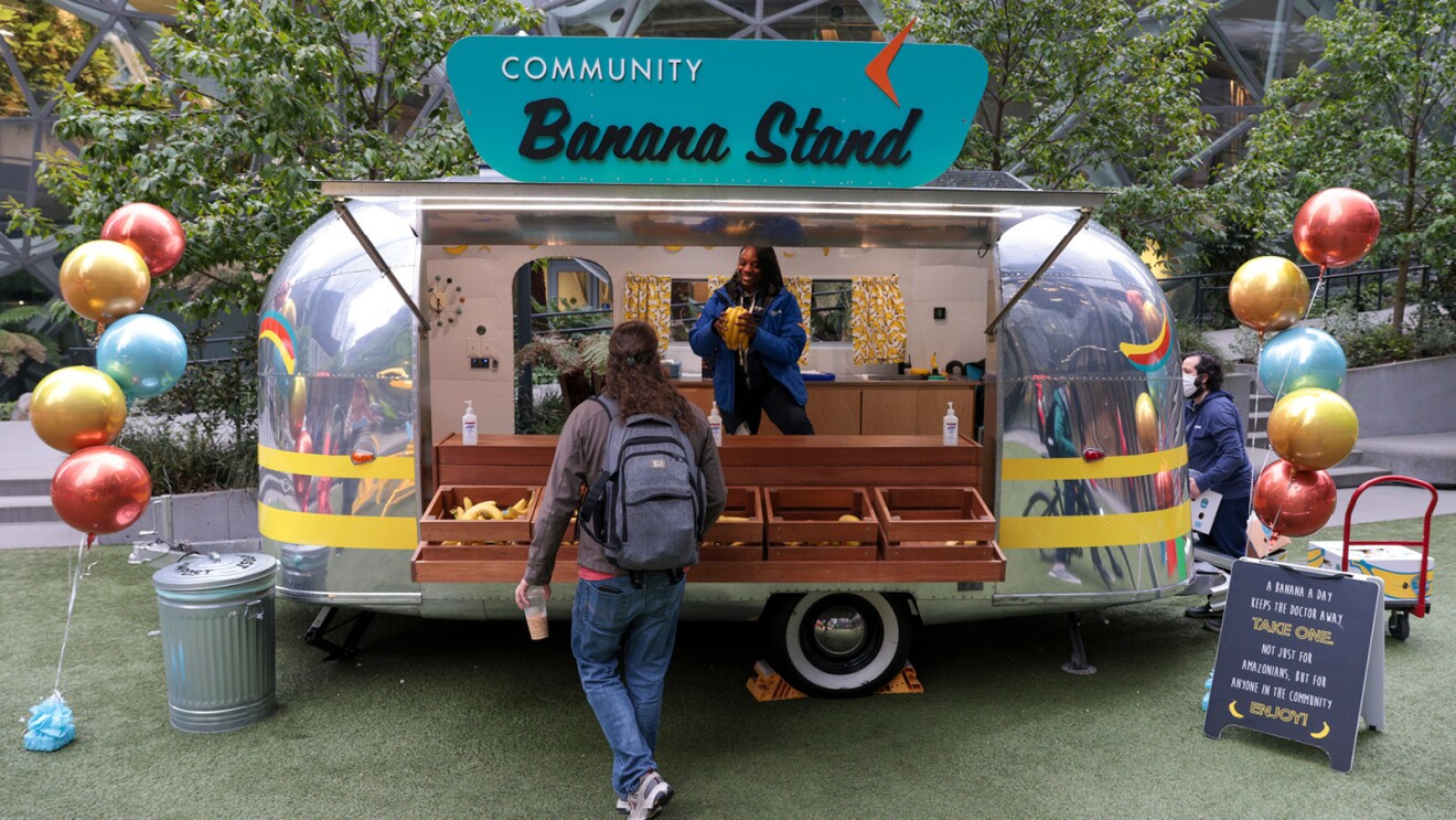 A photo of Amazon employees getting free bananas from the community banana stand outside the Seattle office.