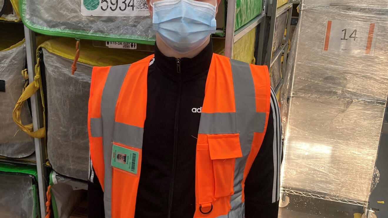 Anson Barratt – Carter, Sortation Associate at Amazon's delivery station in Sheffield, pictured wearing a high visibility vest and a face mask.