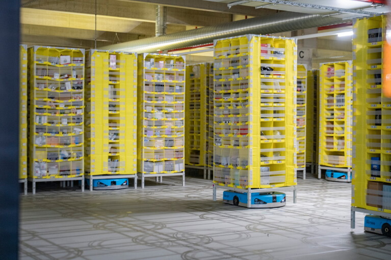 Amazon fulfilment centre with yellow storage pods on blue robots