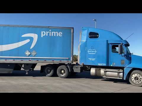 Amazon truck leaves a fulfillment center