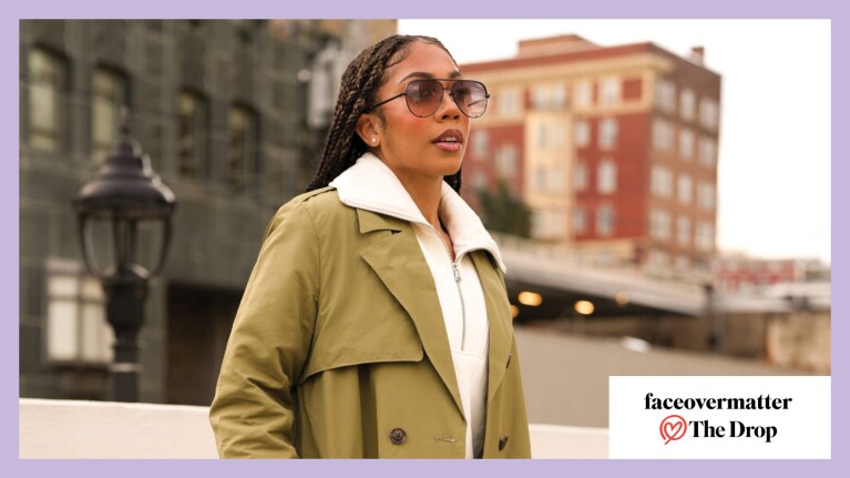 An image of a woman walking outdoors wearing sunglasses and a trench coat. There is a box on the right corner that reads "faceovermatter The Drop"
