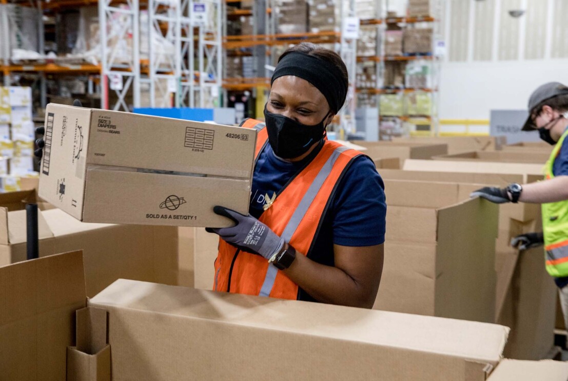 An Amazon employee readies product to be used for disaster relief.