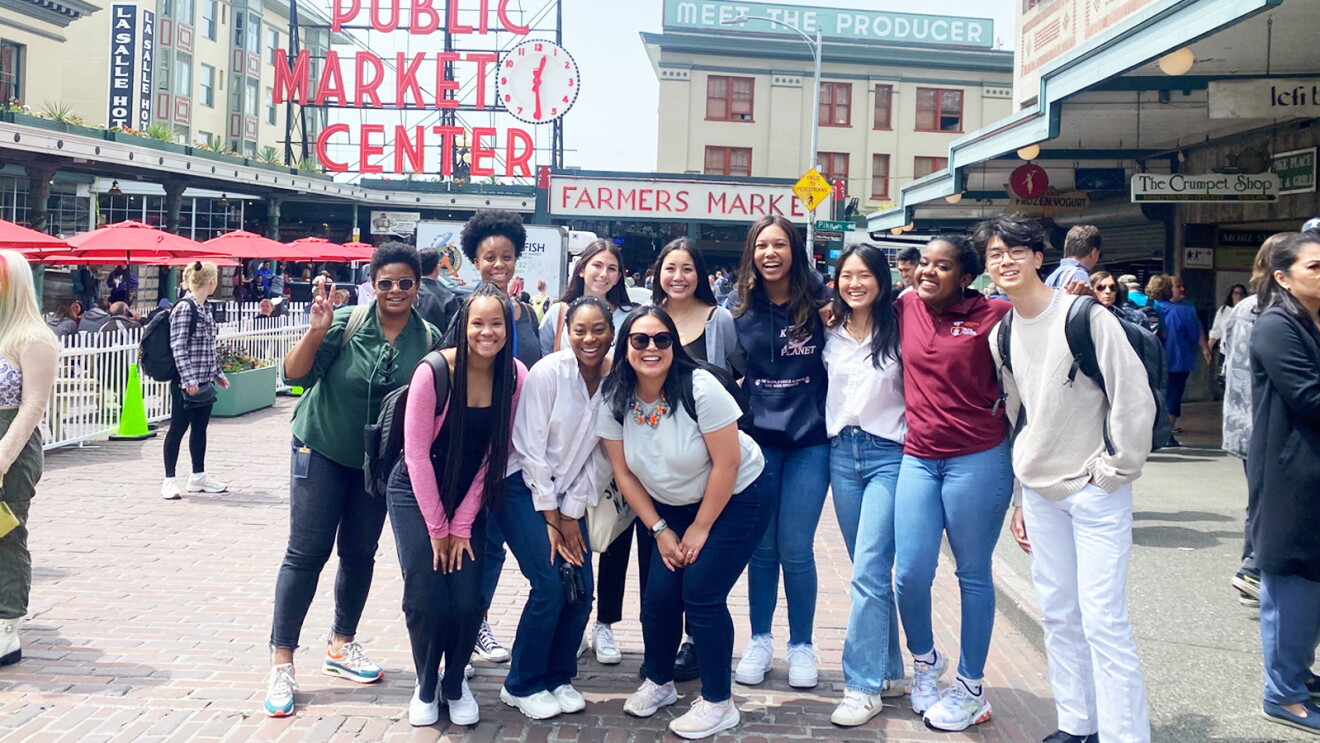 A group picture of Amazon's 2022 public relations internship class at Pike Place Market in Seattle.  