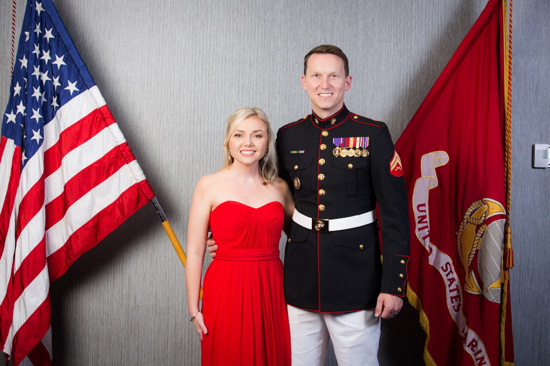 A man poses with his wife at a military event