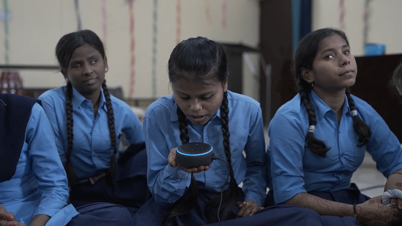 Girls in a UP school with Echo Dot devices