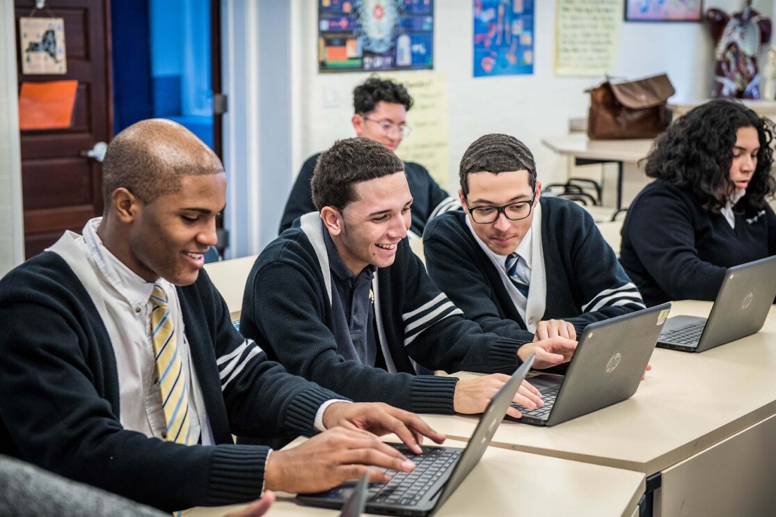 Students at Monsignor Scanlan High School working on laptop computers as they learn about computer science.